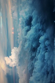 the view from an airplane looking down at clouds and water in the sky, as seen from above