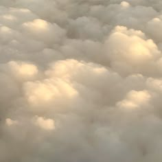 the view from an airplane window shows clouds