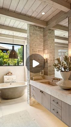 a large bathroom with two sinks and a bathtub in the middle of the room