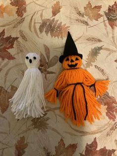 two orange and white halloween decorations sitting on top of a table