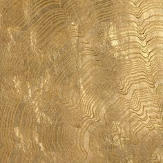 an abstract gold textured background with wavy lines and curves in varying sizes, from the top to the bottom