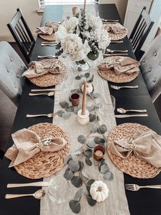 a dining room table set with place settings