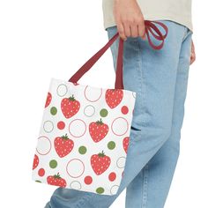 This playful bag features an eye-catching red strawberry design, adding a touch of fun to your everyday routine. Perfect for any adventure, this tote is sure to be your new favorite accessory. Available in 3 sizes to add both functionality and style, these tote bags come with multiple handle colors to match your designs. Made with spun polyester, these bags feature double-stitched seams, cotton webbing straps, and nonwoven laminate lining for high-end durability. .: Made with 100% polyester, a m Trendy Red Canvas Bag With Double Handle, Trendy Red Double Handle Canvas Bag, Casual Bags With Adjustable Strap As Gift, Casual Bags With Adjustable Strap For Gift, Trendy Red Canvas Bag For Shopping, Trendy Red Canvas Bag, Playful Red Shoulder Bag For Daily Use, Playful Red Bag For Gift, Casual Tote Shoulder Bag As Gift