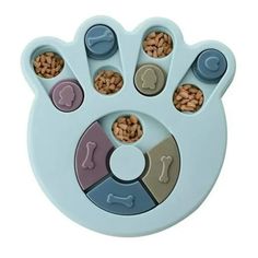 an animal paw shaped toy with various food items in it's center, including nuts and bones