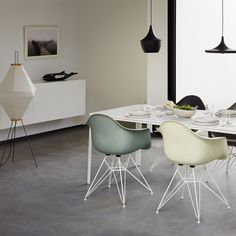 a dining room table with chairs and plates on it