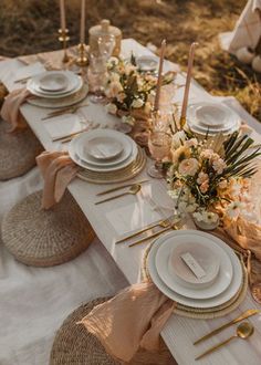 a table set with place settings, plates and napkins for an outdoor dinner party