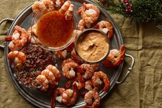 a platter filled with shrimp and dipping sauce