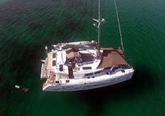 an aerial view of a sailboat in the water