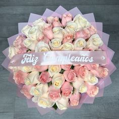 a bouquet of pink and white roses with a ribbon that says filig entangleos