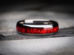 Red hot style. Immerse yourself in the beauty of red and silver with this exquisite tungsten ring, thoughtfully designed to embrace the essence of the earth's wonders. Adorned with a captivating garnet centerpiece, this ring captures fiery hues. Crafted with meticulous attention to detail, the tungsten silver band harmonizes strength and a classic style. The deep red tones of the garnet ruby gemstone evokes the passionate energy of the earth. With our nature-inspired design, this ring becomes a Ruby Wedding Rings Silver, Garnet Ring For Men, Red Mens Wedding Ring, Wedding Prompts, Mens Promise Ring Red Garnet, Garnet Stone Ring For Men, Red Wedding Ring, Red Stone Ring For Men, Ruby Mens Ring