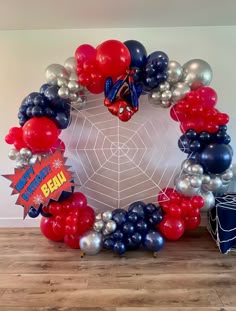 a spiderman balloon wreath with red, white and blue balloons in the shape of an octagon