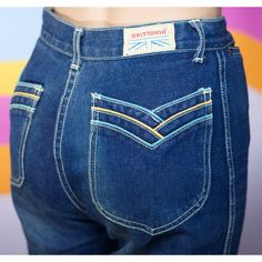 "SUPER CUTE AND RARE early 80s Brittania jeans with pastel blue and yellow piping on the pockets. *Size = X-Small *Inseam = 32.25\" *Waist (high) = 12.25\" flat *Hip = 18\" flat *Fabric = Cotton In good vintage condition, with the wear you would expect for jeans this age. There is a couple of faint brownish spots, and one small hole (see photo). As with all vintage items, please understand this has been previously loved and some wear may be present. I always do my best to accurately photograph and describe the item, but always purchase with the knowledge that vintage items are always 20-90 years old -- but hey, that's what make them awesome! I want every customer to be happy with their purchase, so please purchase with the understanding that vintage items are one-of-a-kind and perfectly im Retro Straight Leg Bottoms With Contrast Stitching, Retro Fitted Jeans, Fitted Retro Jeans, Retro Flare Jeans With Pockets, Vintage Straight Leg Jeans With Contrast Stitching, Vintage Jeans With Button Closure In Medium Wash, Vintage Non-stretch Cotton Jeans, 1970s Full-length Denim Jeans, Vintage Cotton Jeans Pre-washed