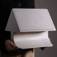 a person holding a white box in their hands