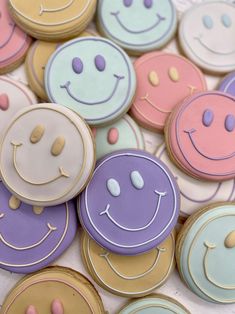 many decorated cookies with smiley faces on them