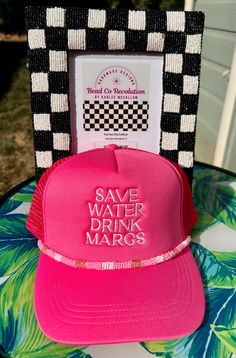 a pink trucker hat with save water drink margs written on the front and side