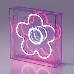 a pink light that is inside of a glass box with a flower on the front