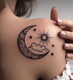 a woman's shoulder with a crescent and stars tattoo on it