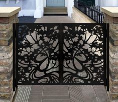 an iron gate with flowers and leaves on it