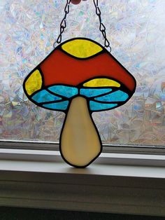 a stained glass lamp hanging from a window