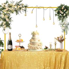 a table topped with a white cake next to a bottle of wine and two vases filled with flowers