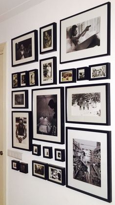 many black and white pictures are hanging on the wall