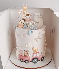 a cake in the shape of a train with animals on it