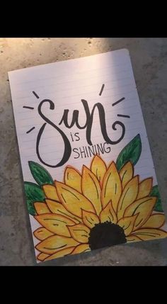 a notepad with the words sup is shining on it and a sunflower painted on top