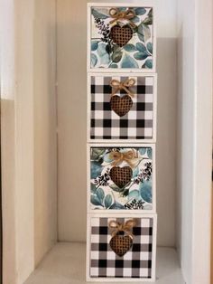 three boxes with hearts on them are sitting in a closet, one is painted black and white