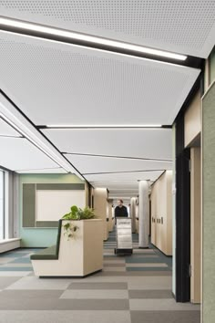 an office hallway with checkered flooring and planters