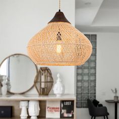 a light that is hanging from the ceiling in a living room with a mirror behind it