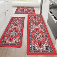 two red rugs on the floor in a kitchen