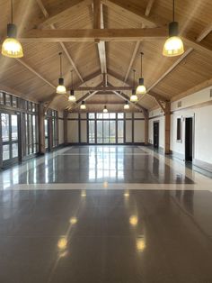 an empty room with high ceilings and large windows