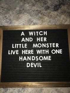 a sign that says a witch and her little monster live here with one handsome devil