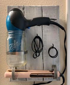 a hair dryer and other items hanging on a wall