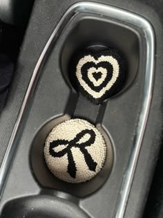 two black and white buttons in the center console of a car