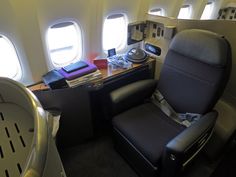 the inside of an airplane with seats and desks