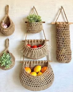 three hanging baskets with fruits and vegetables in them