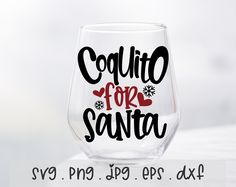 a wine glass with the words coquito for santa written in black on it