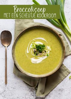 broccoli soup in a bowl with a spoon and napkin