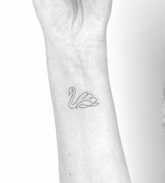 a woman's arm with a small tattoo on the left side of her wrist