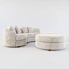 a white couch and ottoman with pillows on it's back end, in front of a gray background