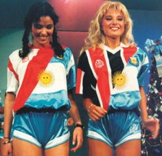 two women standing next to each other in front of a christmas tree wearing matching outfits