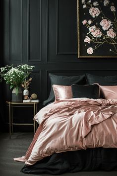 a bedroom with black walls and pink bedding, flowers on the nightstands in front of the bed