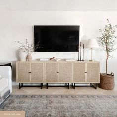 a living room with a large television mounted on the wall