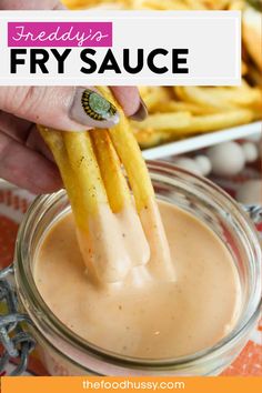 a person dipping french fries into a sauce in a jar with the words copycat friday's fry sauce