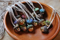 some beads are in a wooden bowl on a table