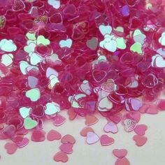 pink and white hearts are scattered on the ground