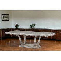 a large white table sitting on top of a hard wood floor