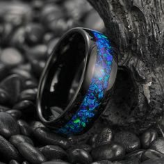 a black ring with blue and green fire opal inlay