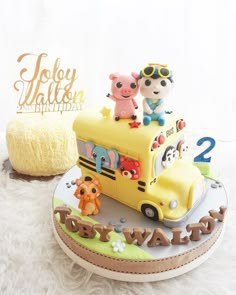 there is a cake that looks like a school bus with animals on the front and sides